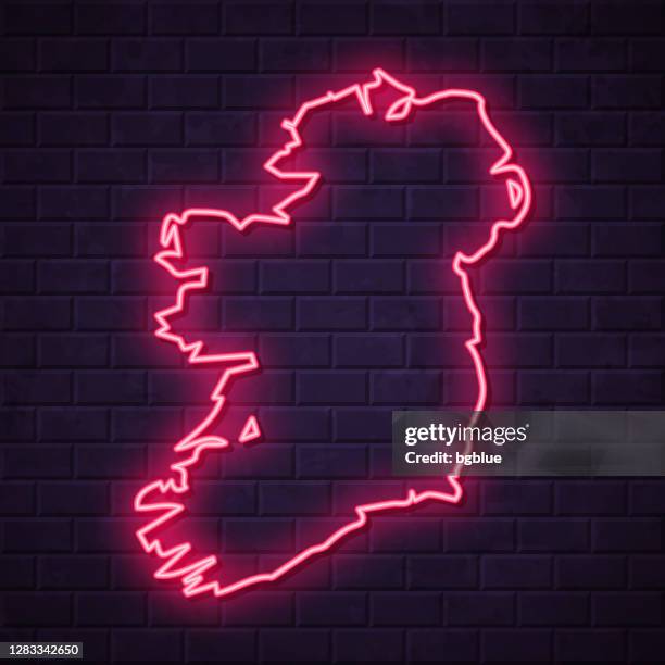 ireland map - glowing neon sign on brick wall background - led light wall stock illustrations