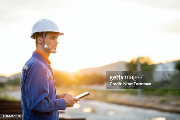 civil engineer or rail track maintenance worker working with touch pad for check railway tracking system. - civil engineering fotografías e imágenes de stock