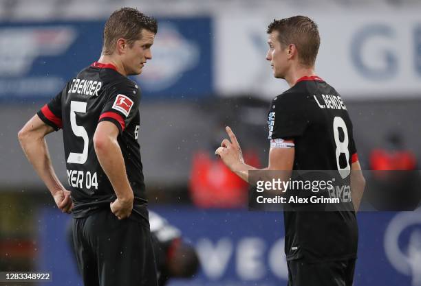 Sven Bender of Bayer Leverkusen talks to teammate and brother Lars Bender during the Bundesliga match between Sport-Club Freiburg and Bayer 04...