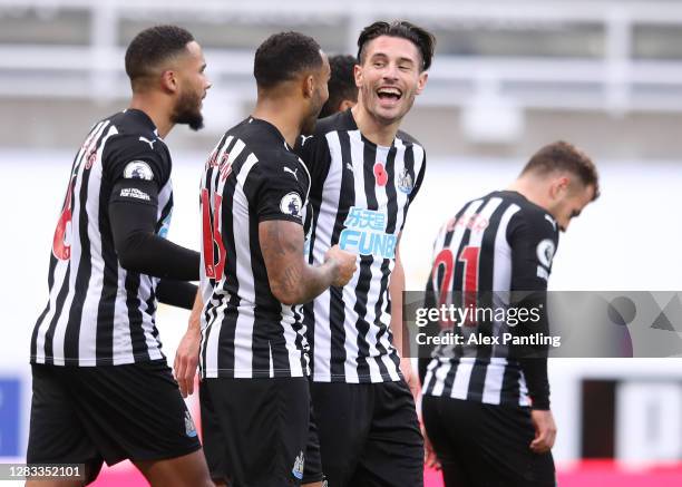 Callum Wilson of Newcastle United celebrates with teammate Fabian Schar after scoring his sides second goal during the Premier League match between...