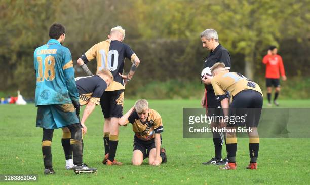 Player goes down injured during a Sunday league football match between Linchfield Lions and Boldmere Wanderers on November 01, 2020 in Lichfield,...