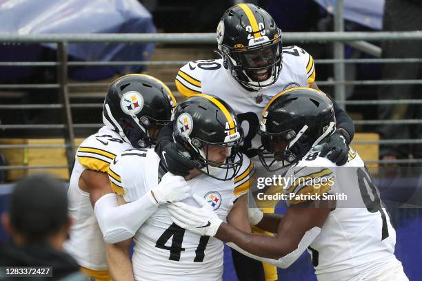 Linebacker Robert Spillane celebrates with cornerback Cameron Sutton of the Pittsburgh Steelers after returning an interception for a first quarter...