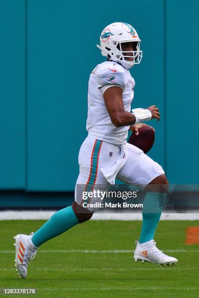 Tua Tagovailoa of the Miami Dolphins scrambles with the ball against the Los Angeles Rams during their NFL game at Hard Rock Stadium on November 01,...