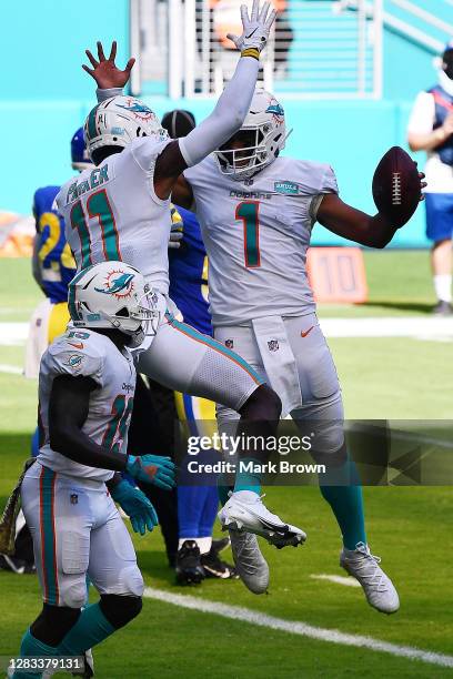 Tua Tagovailoa of the Miami Dolphins celebrates his first NFL touchdown on a three-yard pass to DeVante Parker against the Los Angeles Rams during...