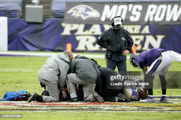 Quarterback Lamar Jackson consoles an injured offensive tackle Ronnie Stanley of the Baltimore Ravens in the first half against the Pittsburgh...