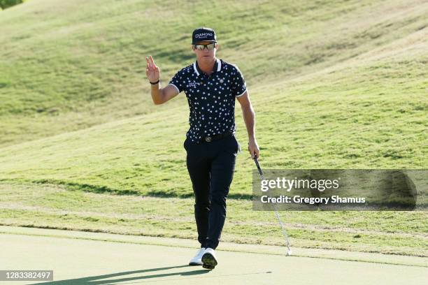 Brian Gay of the United States reacts after putting in for birdie to win a playoff on the 18th green against Wyndham Clark of the United States...