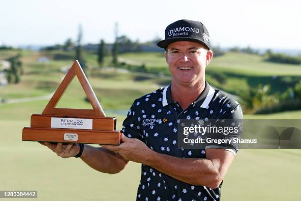 Brian Gay of the United States celebrates with the trophy after winning during a playoff during the final round of the Bermuda Championship at Port...