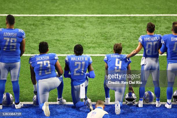 Members of the Detroit Lions kneel during the playing of the national anthem prior to the game against the Indianapolis Colts at Ford Field on...