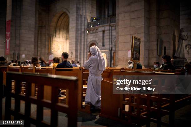 Nun prays during a service inside Sacré Cœur Basilica in Montmartre on All Saints Day on November 01, 2020 in Paris, France. As France faces a second...