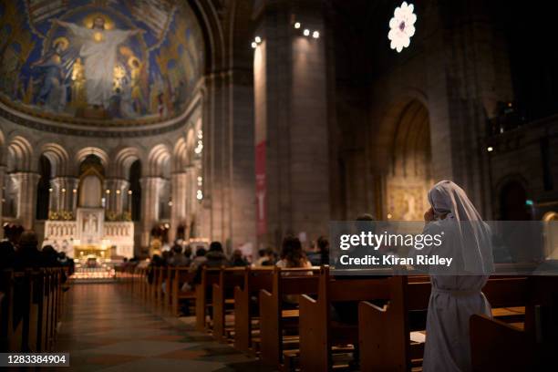 Nun prays during a service inside Sacré Cœur Basilica in Montmartre on All Saints Day on November 01, 2020 in Paris, France. As France faces a second...