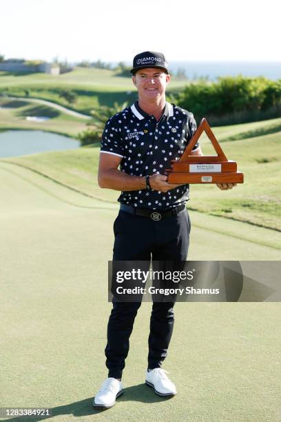 Brian Gay of the United States celebrates with the trophy after winning during a playoff in the final round of the Bermuda Championship at Port Royal...