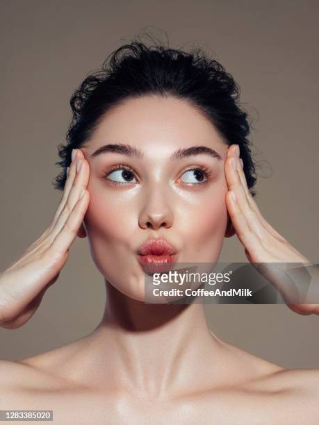close-up portrait of young and beautiful woman - kiss face stock pictures, royalty-free photos & images