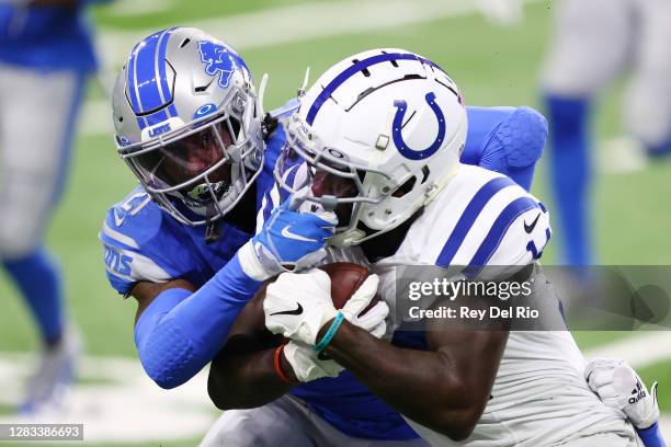 Zach Pascal of the Indianapolis Colts is tackled by Tracy Walker of the Detroit Lions during the first quarter at Ford Field on November 01, 2020 in...