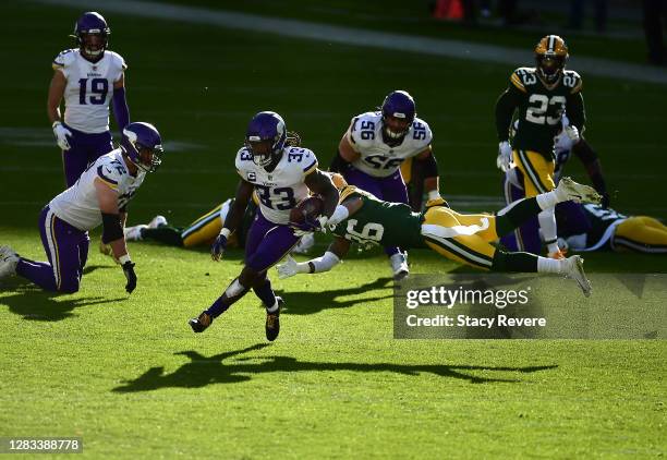 Vernon Scott of the Green Bay Packers misses the tackle on Dalvin Cook of the Minnesota Vikings as he scores during the third quarter of the game at...