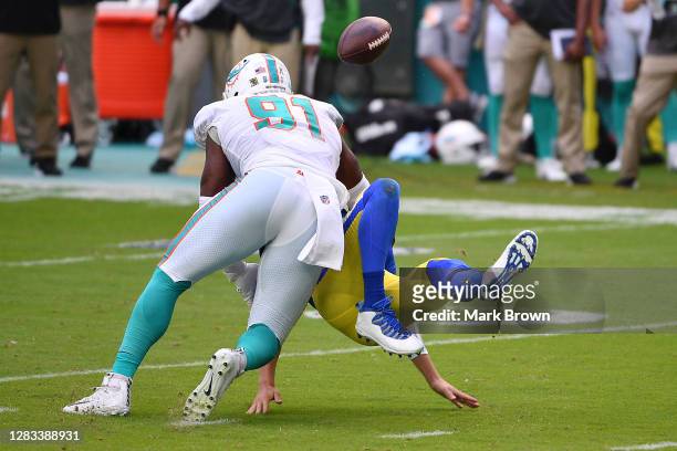 Jared Goff of the Los Angeles Rams fumbles the ball on a hit by Emmanuel Ogbah of the Miami Dolphins during their NFL game at Hard Rock Stadium on...