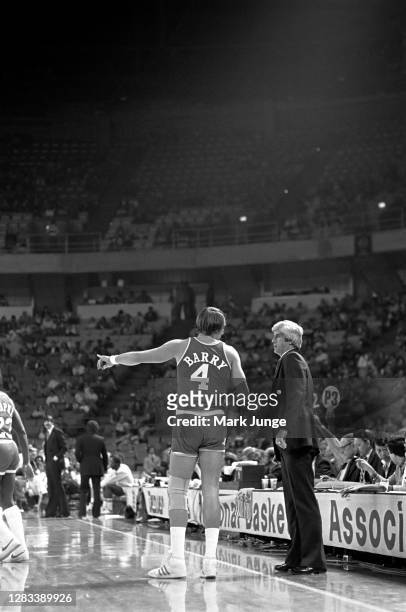 Rick Barry of the Houston Rockets points out an issue to his coach, Del Harris, during a game against the Denver Nuggets at McNichols Arena on...