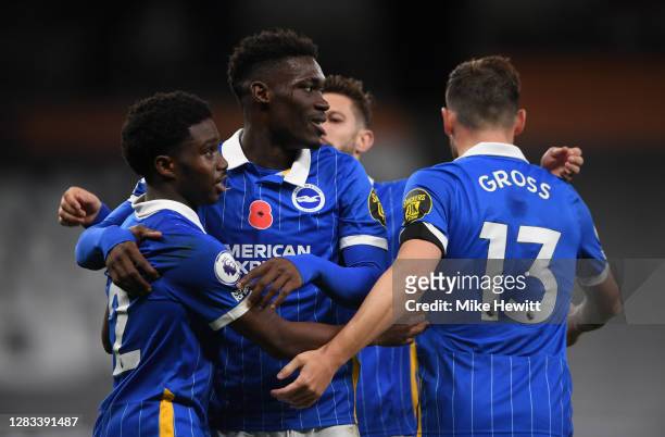 Tariq Lamptey of Brighton and Hove Albion celebrates with teammates Yves Bissouma and Pascal Gross after scoring his sides first goal during the...