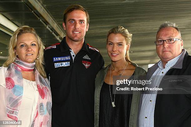 Essendon Bombers AFL player Andrew Welsh poses with family after announcing his retirement to media during a press conference at Windy Hill on...