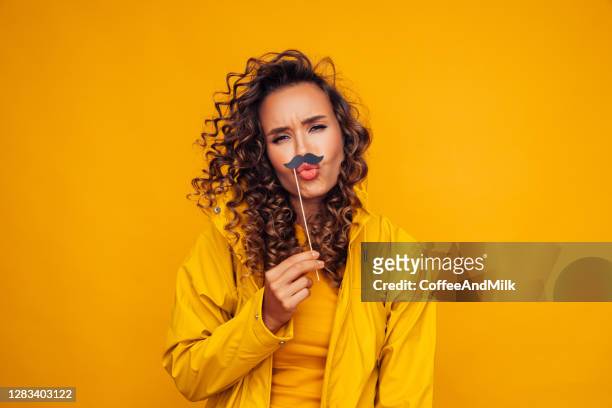 woman in raincoat - coffee moustache stock pictures, royalty-free photos & images