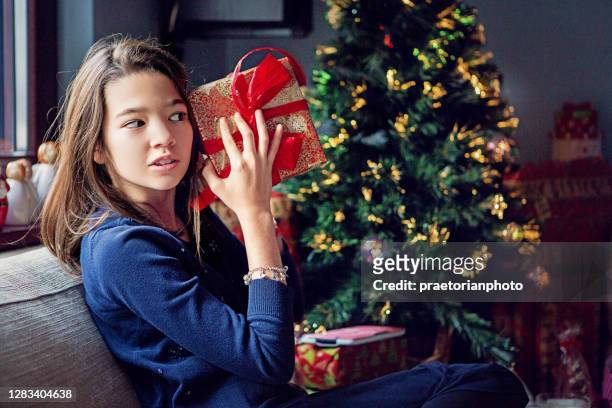 girl is looking her christmas gift - disappointment gift stock pictures, royalty-free photos & images
