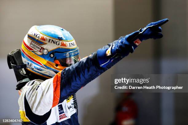 Spanish Renault Formula One driver Fernando Alonso celebrates in Parc Fermé winning the 2008 Singapore Grand Prix at the Marina Bay Street Circuit,...