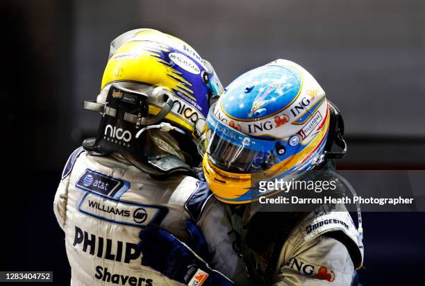 German Williams Formula One driver Nico Rosberg congratulates Spanish Renault Formula One driver Fernando Alonso on winning the 2008 Singapore Grand...