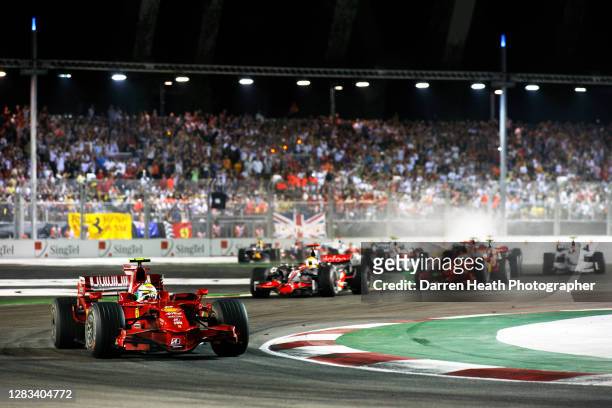 Brazilian Ferrari Formula One driver Felipe Massa turns in to Turn Three of the Marina Bay Street Circuit in his Ferrari F2008 as he leads Lewis...