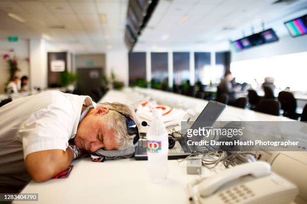 Formula One journalist sleeps at his Media Centre desk as he suffers with jet lag at the 2008 Singapore Grand Prix at the Marina Bay Street Circuit,...