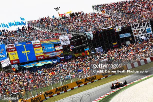 Spanish Renault Formula One driver Fernando Alonso drives his Renault R28 racing car past grandstands packed with thousands of his fans during the...