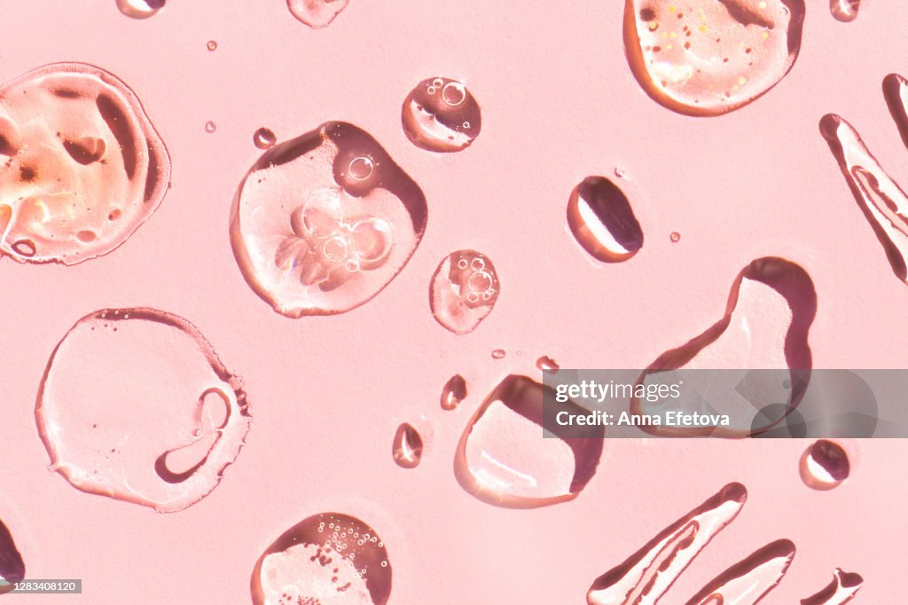 Drops and smears of assorted cosmetic products. Serum and gel - popular liquids of the year