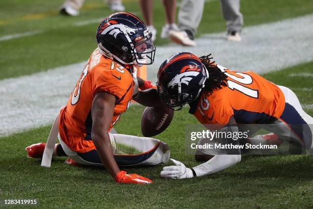 Hamler of the Denver Broncos celebrates with teammate Jerry Jeudy after scoring a touchdown against the Los Angeles Chargers at the end of the fourth...