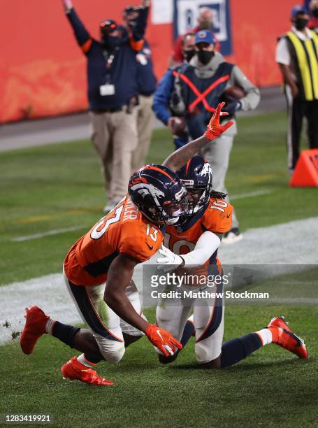 Hamler of the Denver Broncos celebrates with teammate Jerry Jeudy after scoring a touchdown against the Los Angeles Chargers at the end of the fourth...