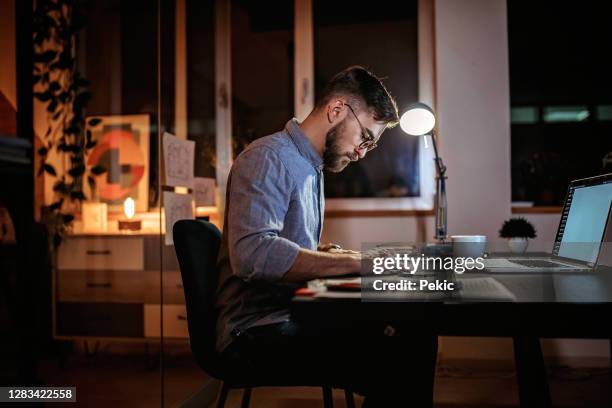 working from home during night time - ruler desk stock pictures, royalty-free photos & images