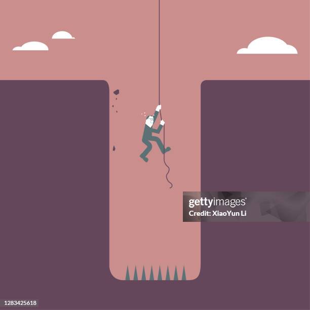 a man escaped the trap using a rope,sharp thorns in the trap. - hole stock illustrations