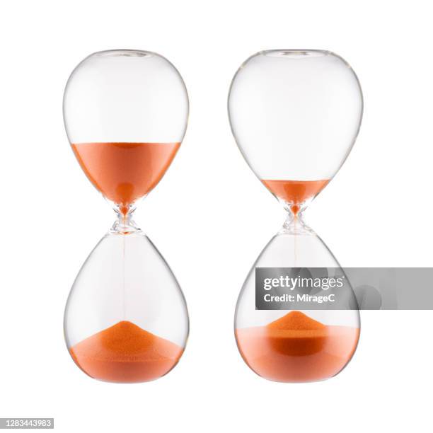 orange colored sand hourglass - hourglass stock pictures, royalty-free photos & images