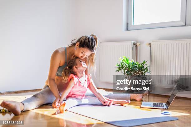 pregnant mother practicing yoga with daughter at home - prenatal yoga stock pictures, royalty-free photos & images