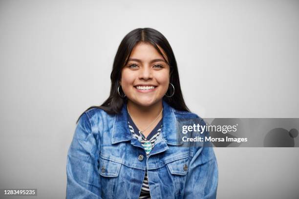 colombian happy woman standing against white background - university student portrait stock pictures, royalty-free photos & images