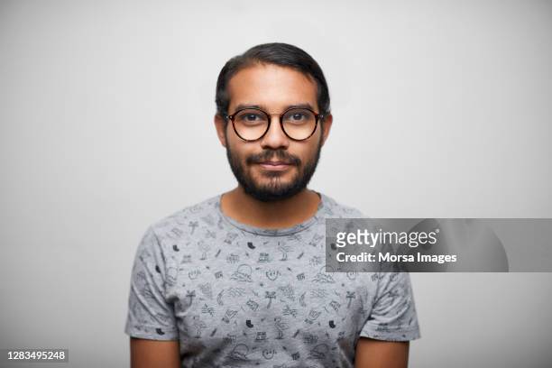 smiling latin american student man standing against white background - formal portrait foto e immagini stock