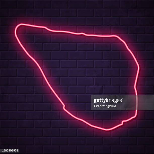 navassa island map - glowing neon sign on brick wall background - led light wall stock illustrations