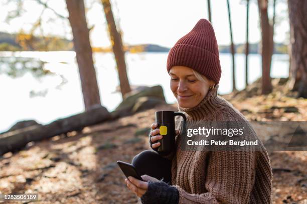 autumn morning - woman smartphone nature stock pictures, royalty-free photos & images