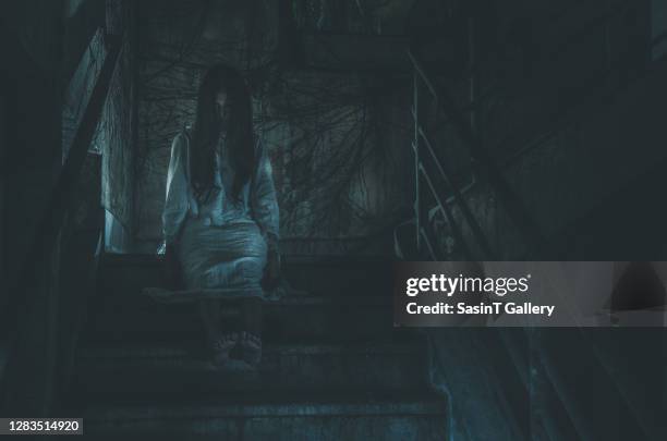 ghost woman on haunted staircase - zombie girl ストックフォトと画像