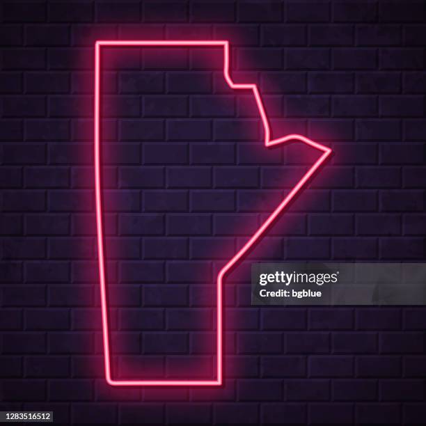 manitoba map - glowing neon sign on brick wall background - manitoba stock illustrations