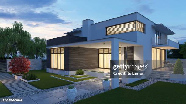 luxurious beautiful modern villa with front yard garden at sunset. - arab villa stock pictures, royalty-free photos & images