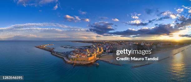 aerial view of the old village of termoli and its beach during sunset - campobasso province, molise region, italy. - molise stock-fotos und bilder