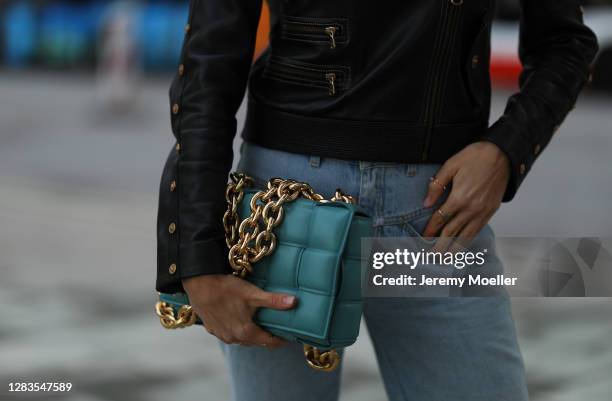 Alena Gerber wearing blue Closed jeans, Bottega Veneta bag and black Versace leather jacket on October 23, 2020 in Hamburg, Germany.