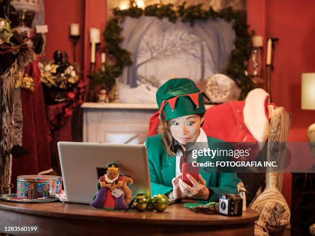 christmas elf on a video conference call - north pole elves stock pictures, royalty-free photos & images