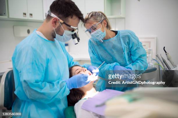 dentist examining patient mouth in medical clinic. - dentist office stock pictures, royalty-free photos & images
