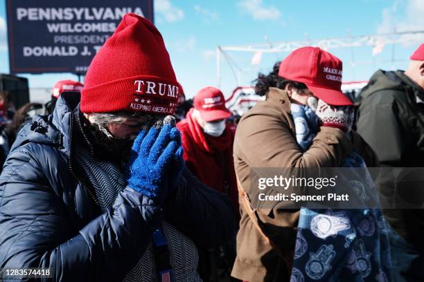 Supporters pray at a President Donald Trump rally on November 02, 2020 in Avoca, Pennsylvania. Donald Trump is crossing the crucial state of...