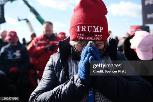 Supporters pray at a President Donald Trump rally on November 02, 2020 in Avoca, Pennsylvania. Donald Trump is crossing the crucial state of...