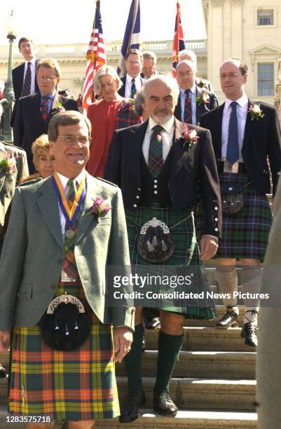 Accompanied by American politician and US Senate Majority Leader Trent Lott and others , Scottish actor Sir Sean Connery walks down the steps of the...